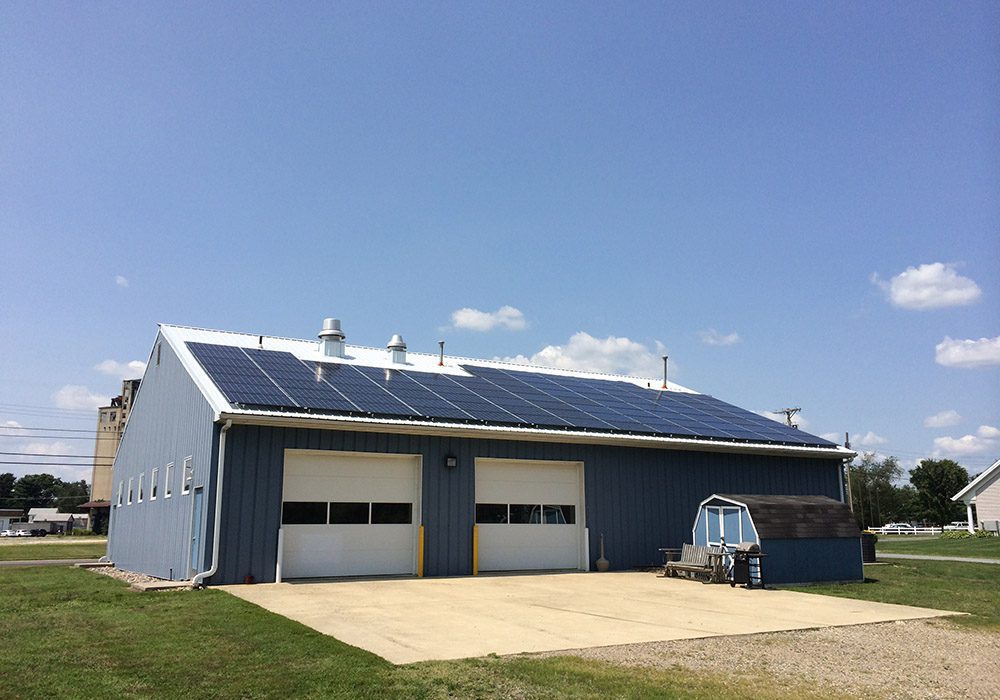 Roof-mounted solar panels on a blue Ambulance squad building